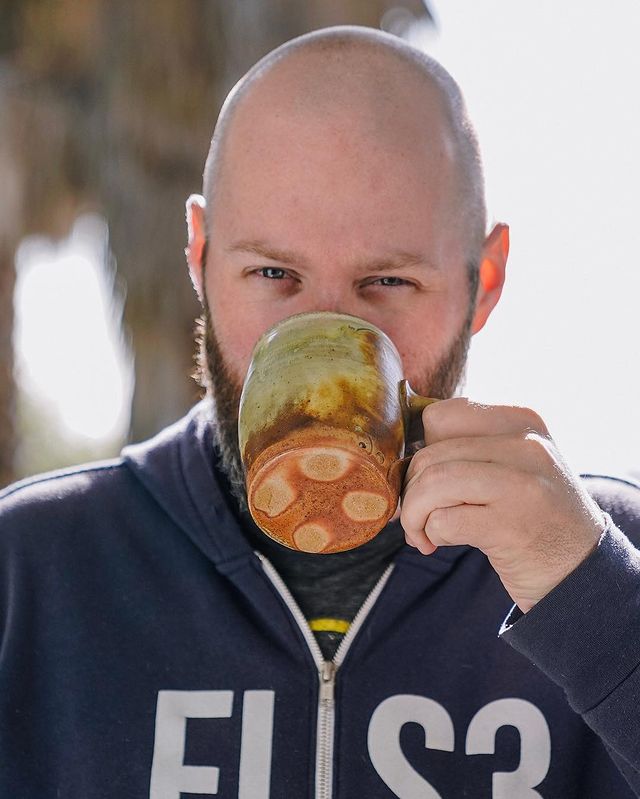Lee Boxleitner drinking coffee in a beautifully printed cup.